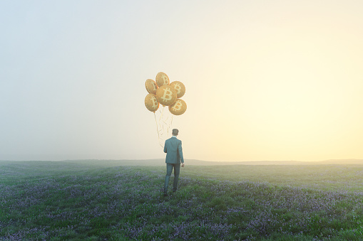 Businessman walking with bitcoin balloons. Entirely 3D generated image.