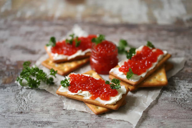istock Crackers with red caviar and cream cheese. 1308318583