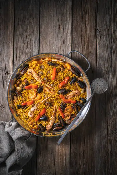 Seafood paella fidegua fideua recipe from Spain in a paellera made with noodles instead rice, with shrimp, crawfish, clams and mussels, spanish food.