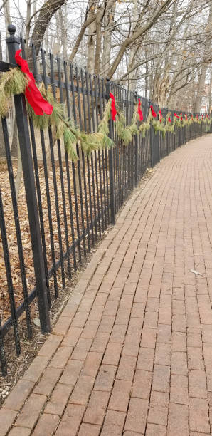 Bricked pathway with fence decorated with garland