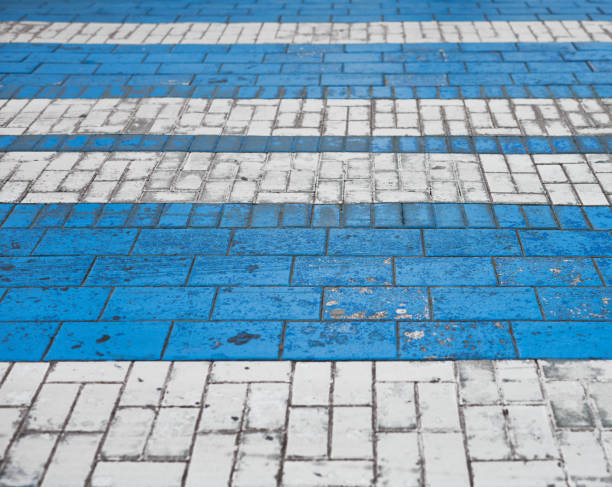 istock side view of a blue and white crosswalk on a cobblestone roadway 1308324899