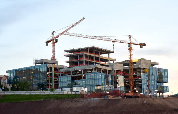 istock Construction site with new buildings and cranes at dusk evening yellow cloudy sky background, sunlight, back light 1308326269