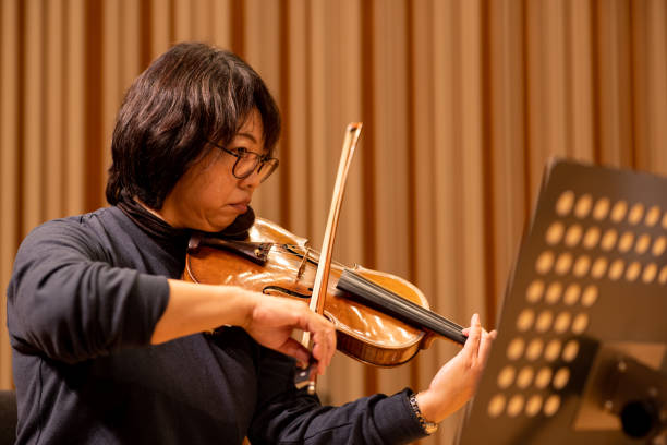 istock Musician playing violin at classical music concert 1308328885
