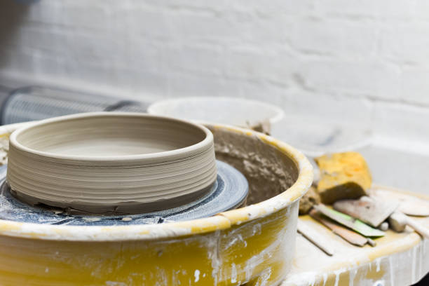 istock Pottery wheel with ceramics tools for making art and craft objects from clay in a workshop studio 1308332045
