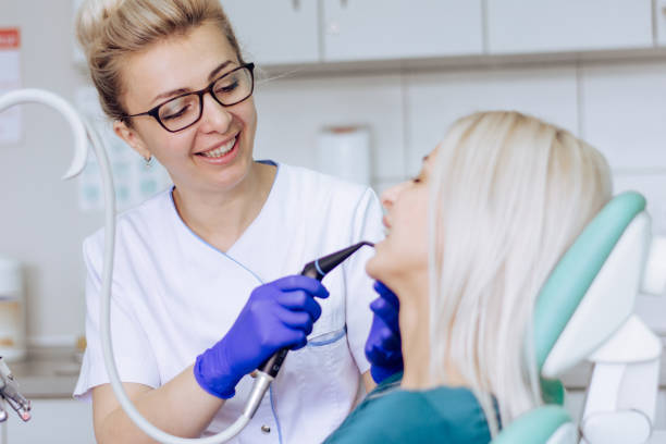 istock Female dentist is working with her patient 1308332855