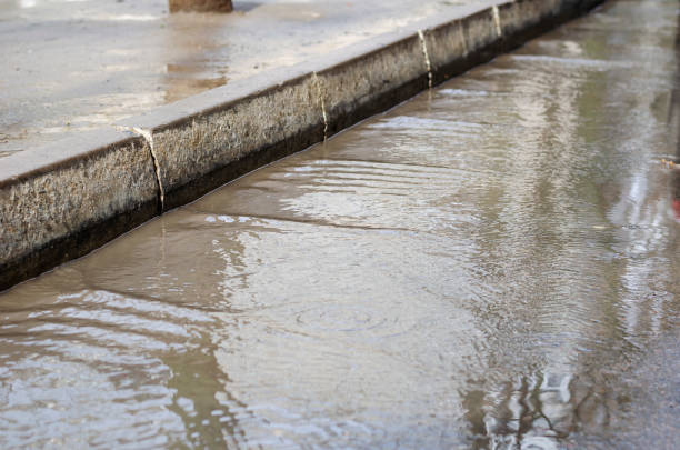 istock Blurred motion, Stream of rainwater on the road. 1308334627