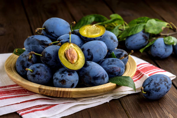 istock Ripe juicy plums on a plate 1308336156