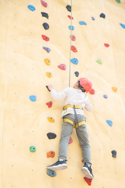 istock Young boy climbing wall outdoors 1308338862