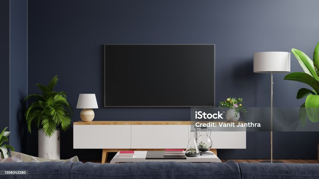 Mockup tv on cabinet in modern empty room with behind the dark blue wall. Mockup tv on cabinet in modern empty room with behind the dark blue wall.3d rendering Television Set Stock Photo