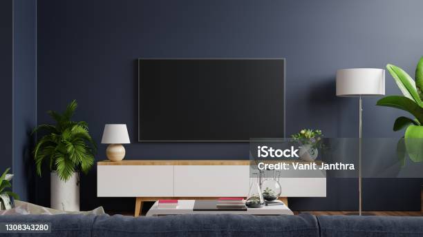 Mockup Tv On Cabinet In Modern Empty Room With Behind The Dark Blue Wall Stock Photo - Download Image Now