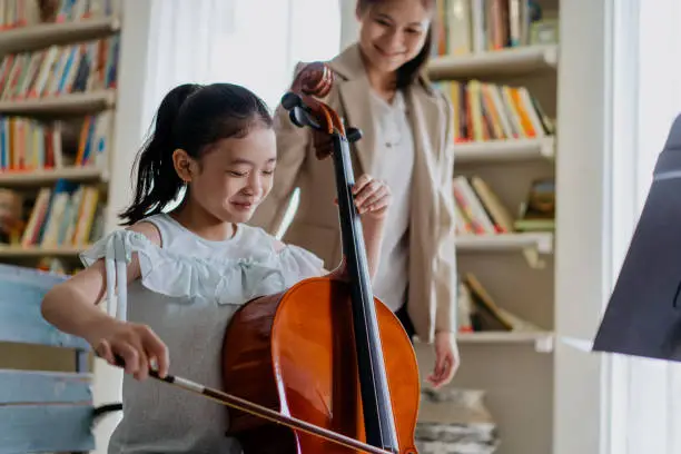 Photo of Little Girl Learning to play Cello