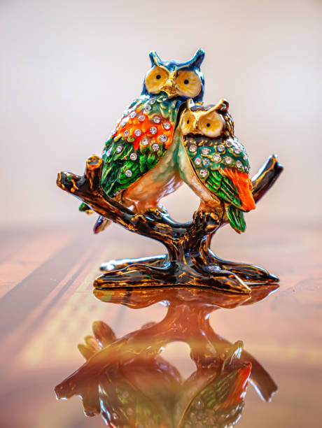 istock Figure of two owls sitting on a branch 1308347028