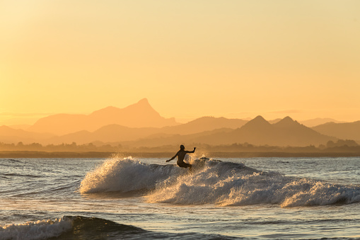 Surfing  at sunset