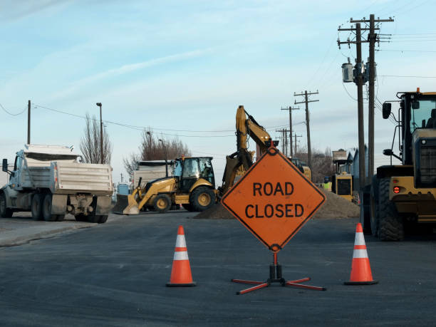 istock Road closed sign for work construction heavy equipment 1308349935