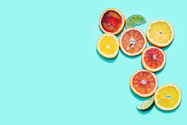 istock Bright slices citrus fruits, grapefruit, red orange, lemon, lime on pastel turquoise background. Minimal fruit and summer concept. 1308350727