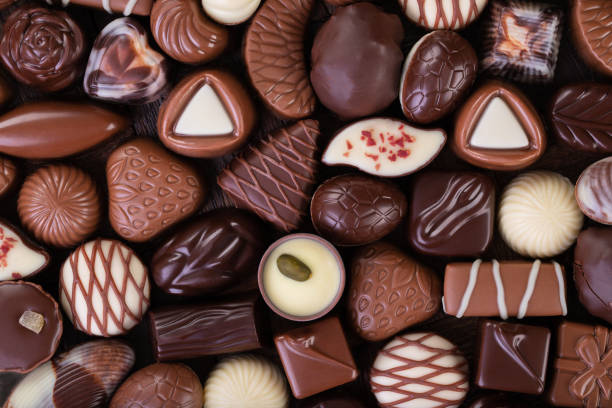 istock chocolate candies background, sweet dessert as a background, top view. 1308356691