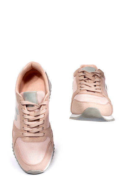 istock Light pink summer sneakers on a white background 1308359155