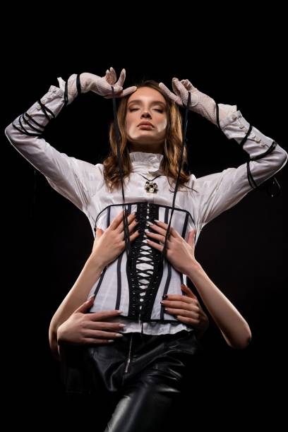 istock Stylish woman in corset standing in studio 1308359231