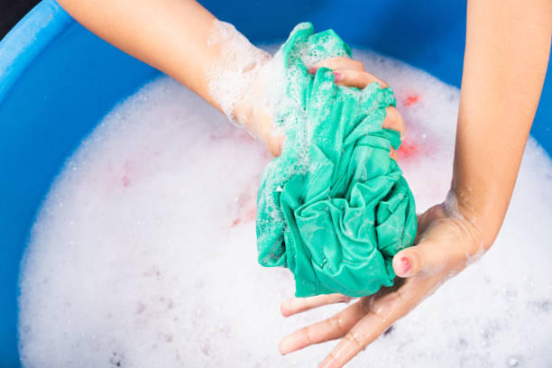 istock Female squeeze wring out wet fabric cloth 1308361894