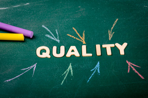 istock QUALITY. Colored pieces of chalk on a green chalk board 1308362499