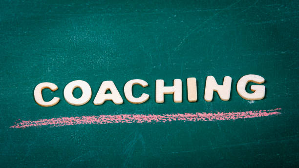 istock COACHING. Colored pieces of chalk on a green chalk board 1308362502