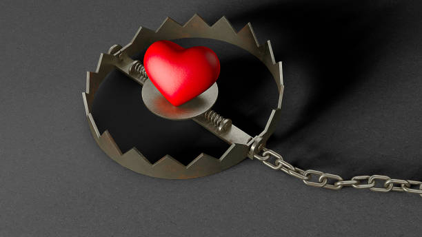 istock Heart in a trap. Red heart bait in a trap 1308363487