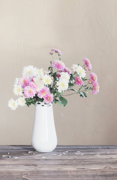 istock chrysanthemums in  vase on old wooden table 1308363587