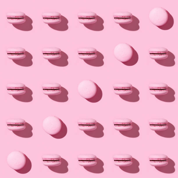 istock Seamless regular creative pattern of colorful french cookies macarons. Monochrome image. 1308365395