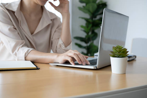 istock Young woman accountant concentrate working on laptop computer at modern workplace. 1308366922