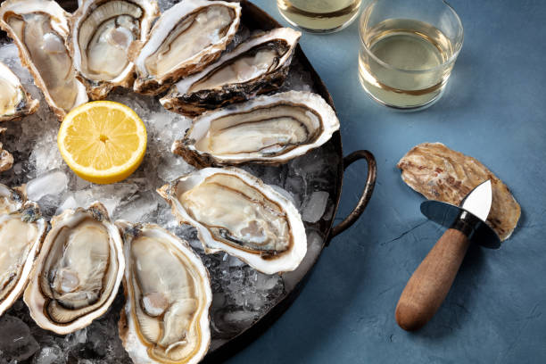 istock Oyser platter close-up with lemon, wine and an oyster knife 1308367152