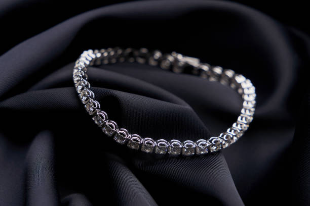istock Platinum bracelet with diamonds on black silk background 1308369232
