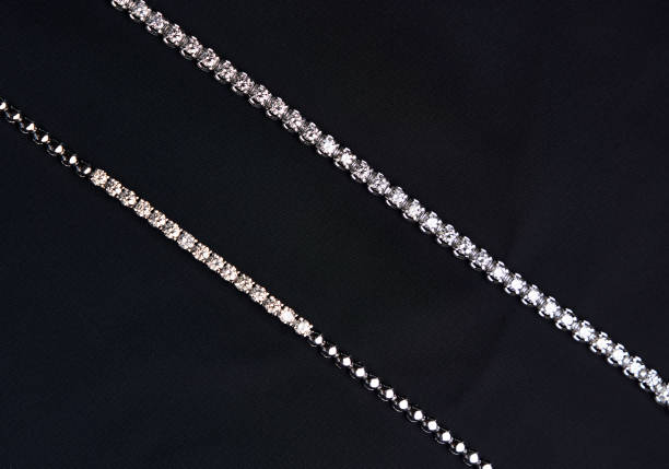 istock Platinum bracelet with diamonds on black silk background 1308369253
