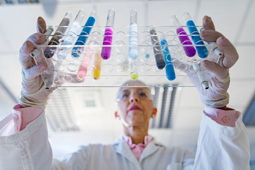 Low angle view of a senior female scientist working on antiviral drug in laboratory.