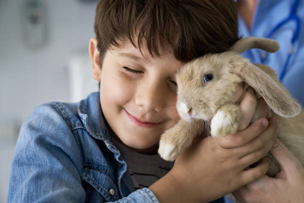 istock Portrait of Affectionate Young Boy with Pet Rabbit 1308372316