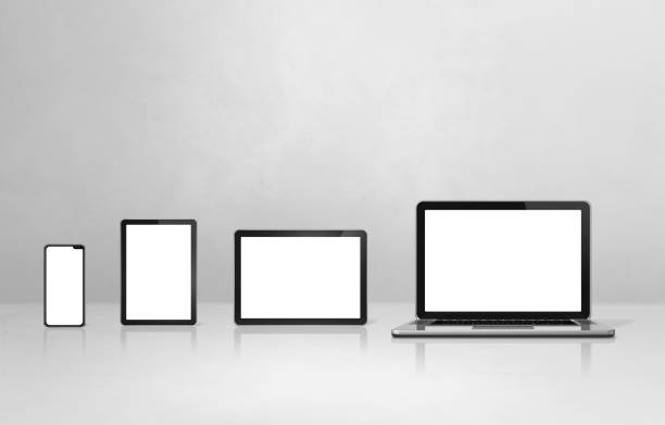 istock Laptop, mobile phone and digital tablet pc on white concrete office desk 1308373224