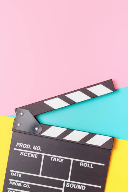 istock The clapper board on pink, yellow and blue background close-up. 1308374008