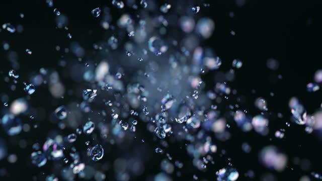 Dark liquid drops flying in super slow motion 4K