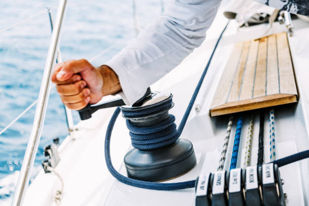 istock Sailor winding rope on winch with hands 1308376553