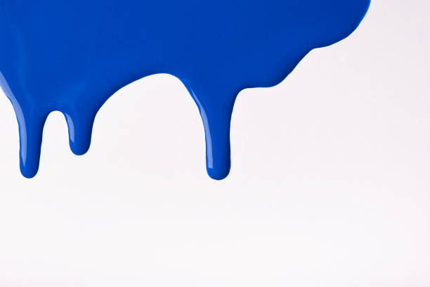 istock Navy blue liquid drops of paint color flow down on isolated white background. Abstract sapphire backdrop 1308377149