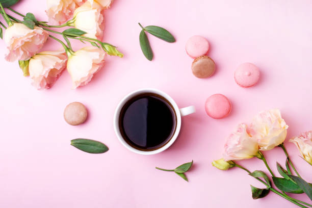 istock Pink eustoma flowers, morning coffee and macarons on a pink background. Concept for Valentine's Day and wedding. Flat lay style 1308377369