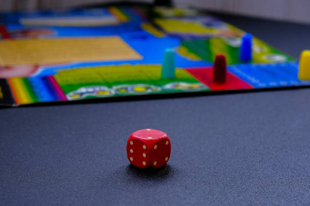 istock Dice for board games on black background. Board game with multi-colored cubes on table game. Stay home leisure activity 1308377485