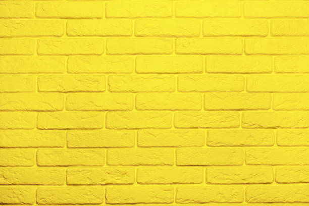 istock Yellow brick wall background. Trend color 2021 yellow 1308377738