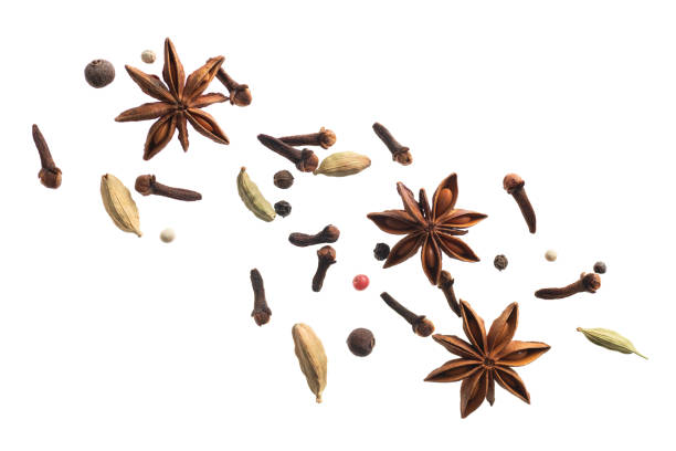 various flying spices for making masala tea isolated on white background