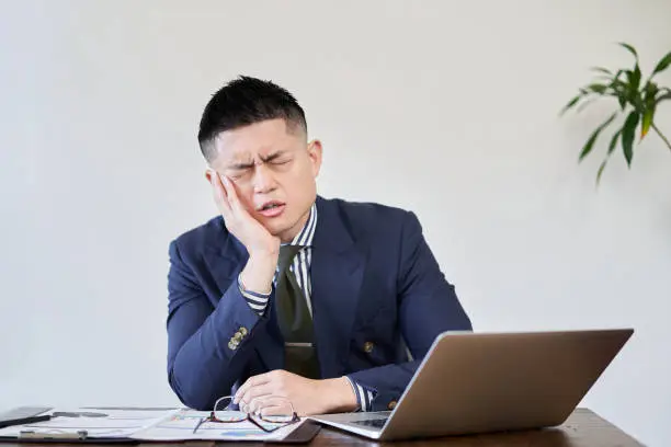 Asian businessman worried about work