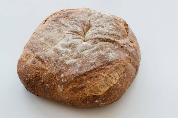 istock Freshly baked traditional bread on white table 1308381202