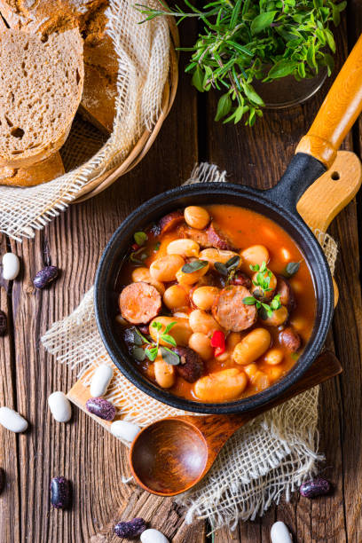 istock Delicious bean stew with sausage and potato 1308381380