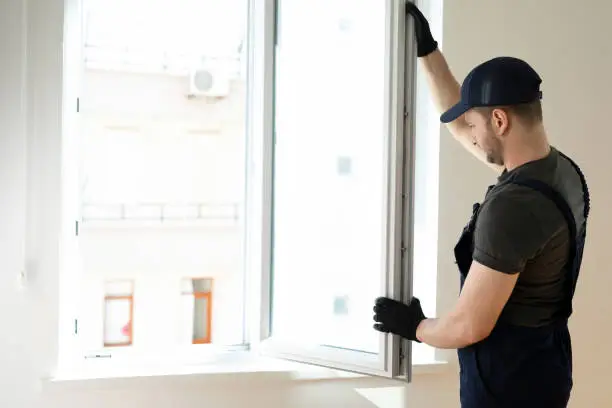 Photo of Handyman fixing the window