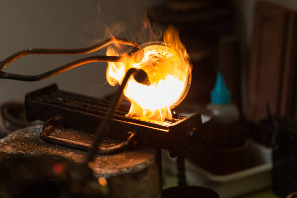 istock melting with blow torch and foundry of liquid silver from a bowl into a mold 1308385596