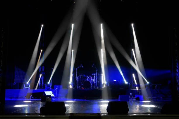 istock scene, stage light with colored spotlights and smoke 1308387728