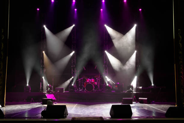 istock scene, stage light with colored spotlights and smoke 1308387744
